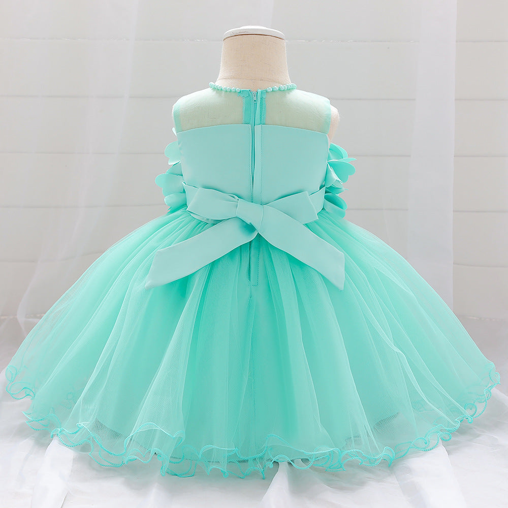 Baby girl wearing a petal patched design sleeveless full moon christening mesh dress in a beautiful floral pattern.