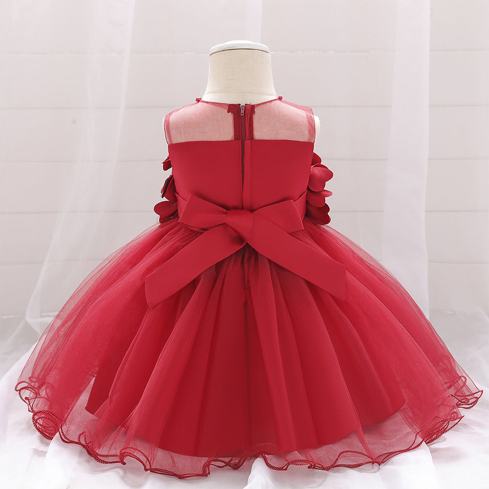 Baby girl wearing a petal patched design sleeveless full moon christening mesh dress in a beautiful floral pattern.