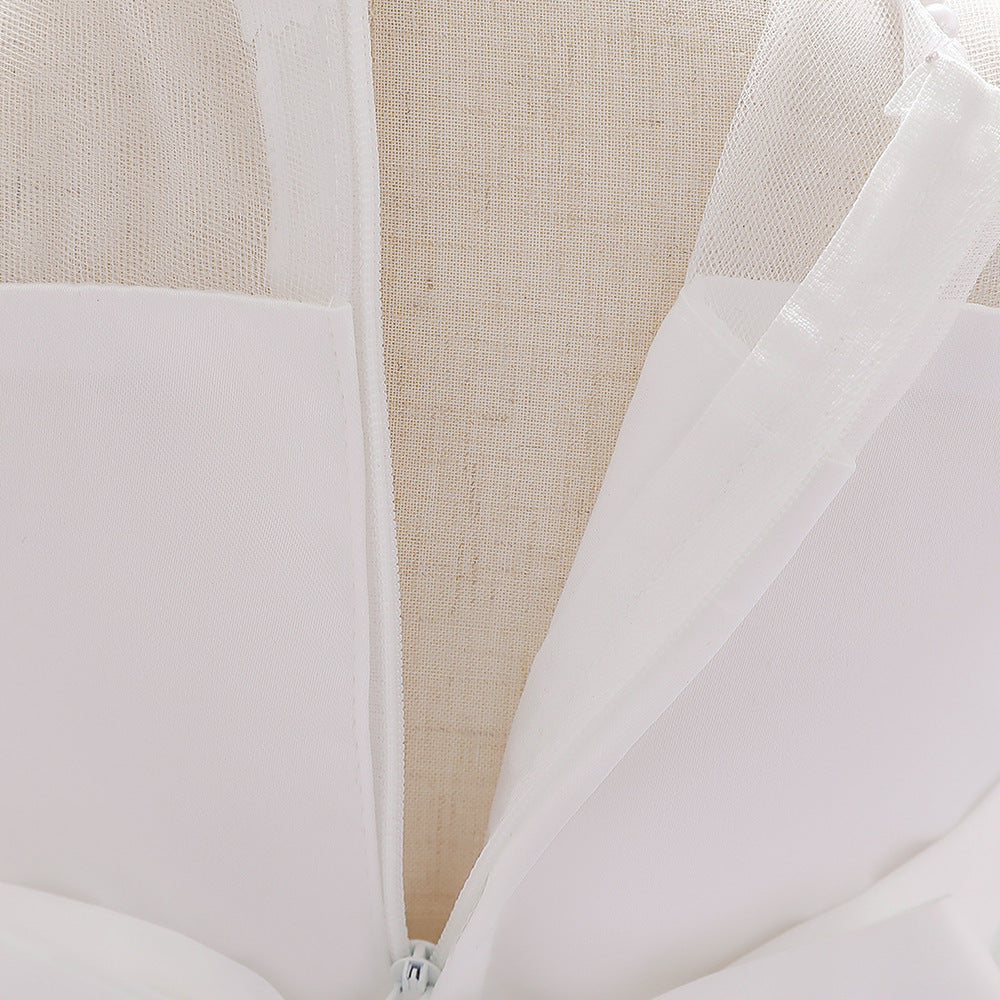 Baby girl wearing a petal patched design sleeveless full moon christening mesh dress in a beautiful floral pattern.