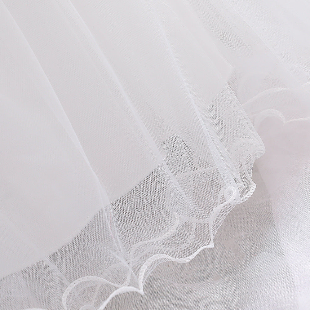 Baby girl wearing a petal patched design sleeveless full moon christening mesh dress in a beautiful floral pattern.