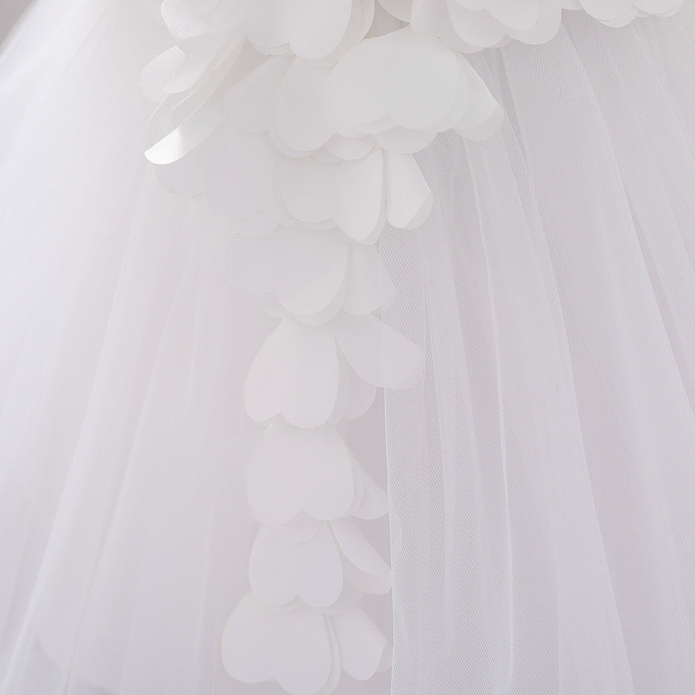 Baby girl wearing a petal patched design sleeveless full moon christening mesh dress in a beautiful floral pattern.