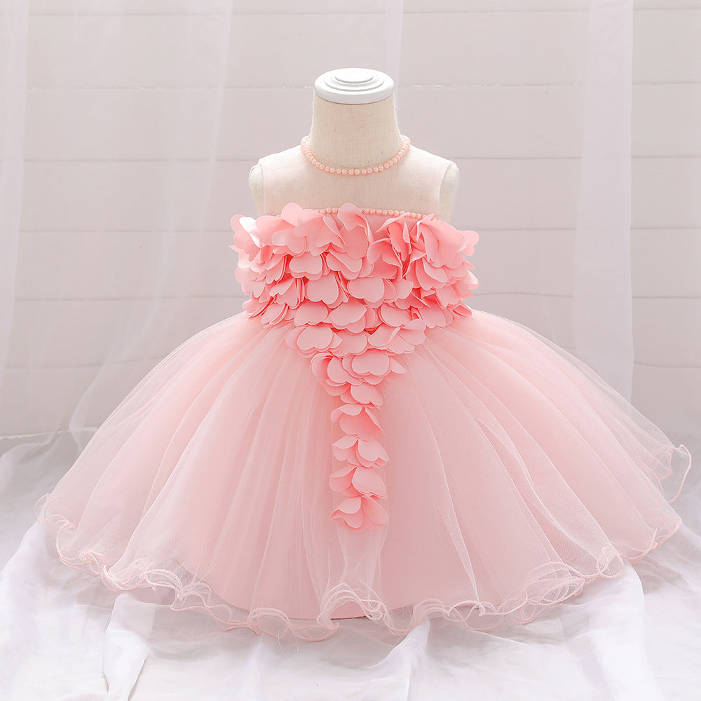 Baby girl wearing a petal patched design sleeveless full moon christening mesh dress in a beautiful floral pattern.