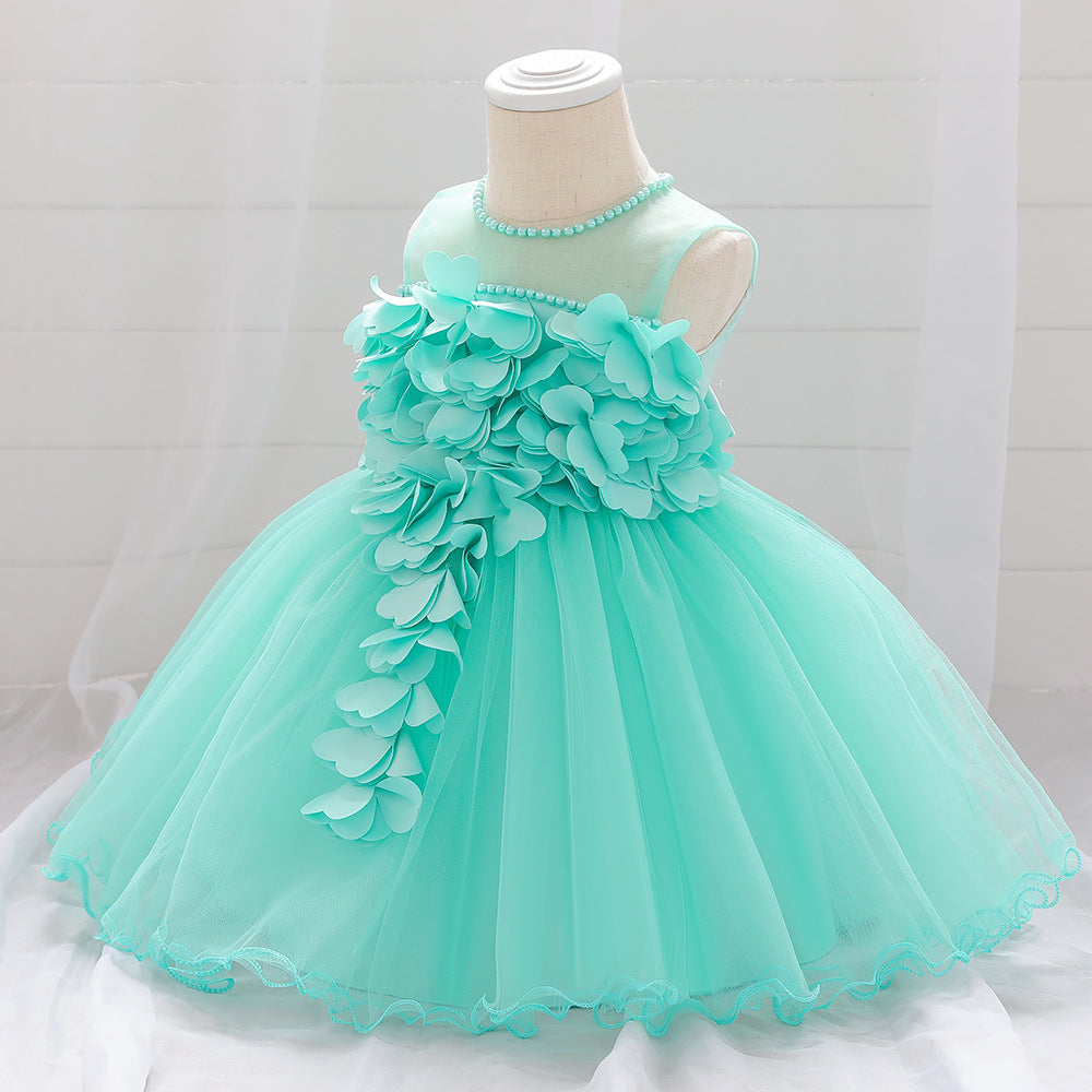 Baby girl wearing a petal patched design sleeveless full moon christening mesh dress in a beautiful floral pattern.