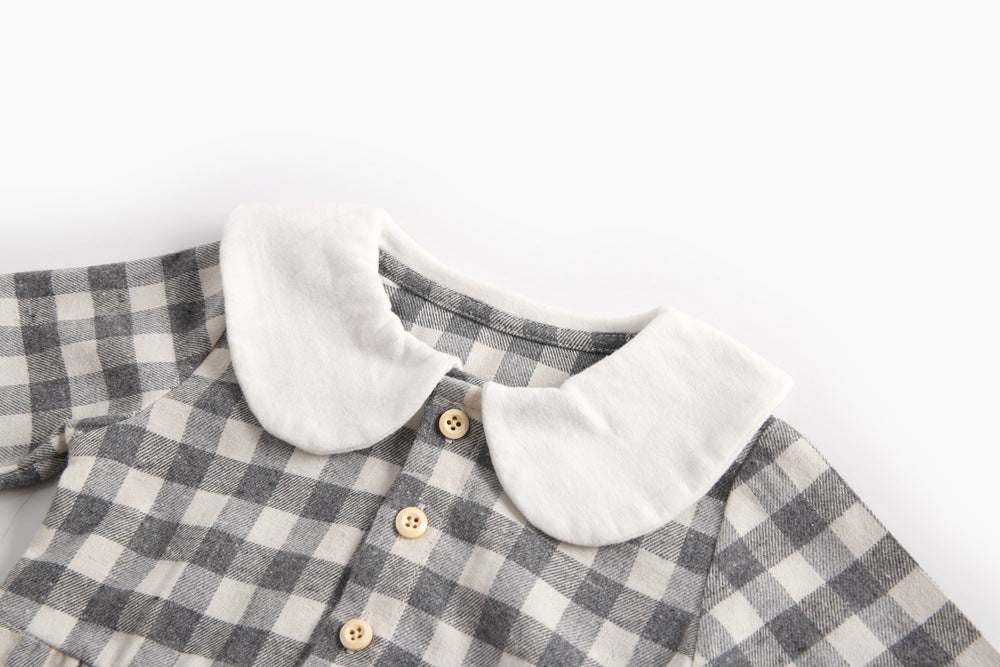 Baby girl long sleeve onesie featuring a plaid pattern and doll collar design in black and grey colors.