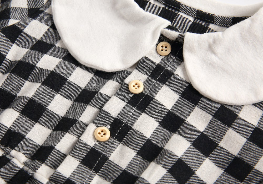 Baby girl long sleeve onesie featuring a plaid pattern and doll collar design in black and grey colors.