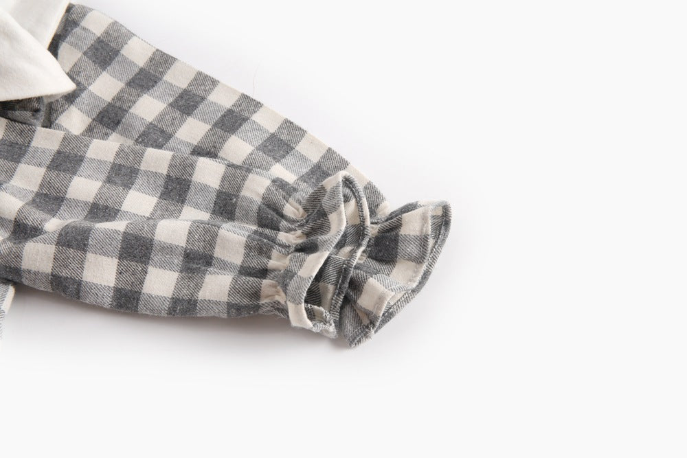 Baby girl long sleeve onesie featuring a plaid pattern and doll collar design in black and grey colors.