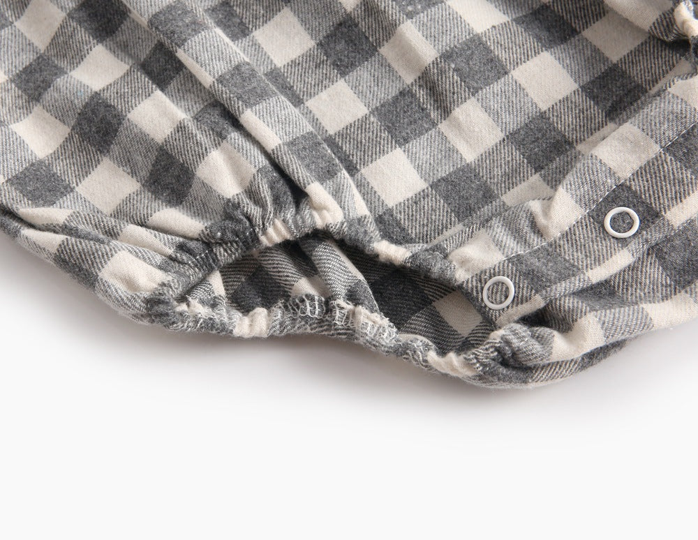 Baby girl long sleeve onesie featuring a plaid pattern and doll collar design in black and grey colors.