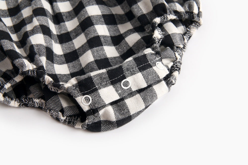 Baby girl long sleeve onesie featuring a plaid pattern and doll collar design in black and grey colors.