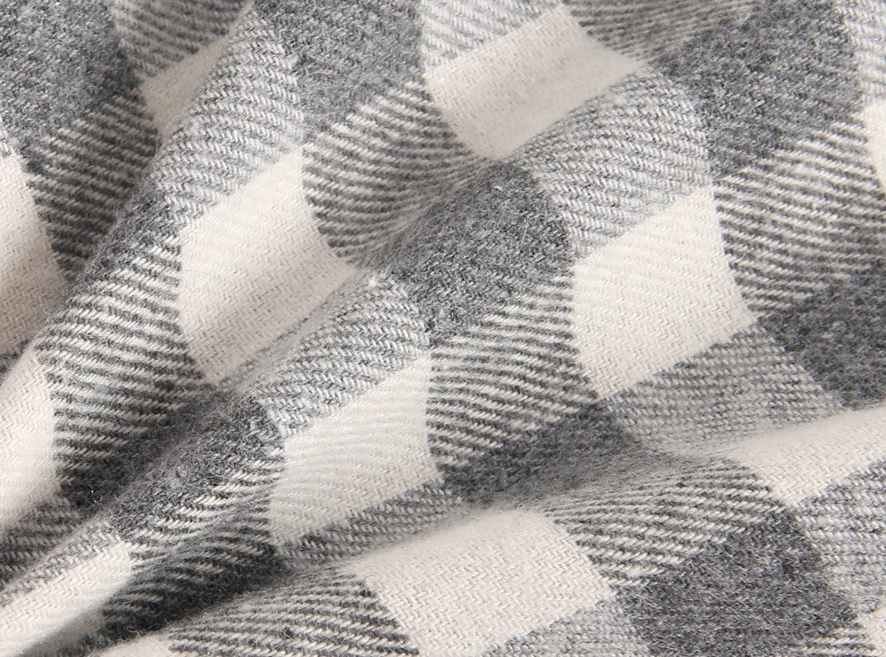 Baby girl long sleeve onesie featuring a plaid pattern and doll collar design in black and grey colors.