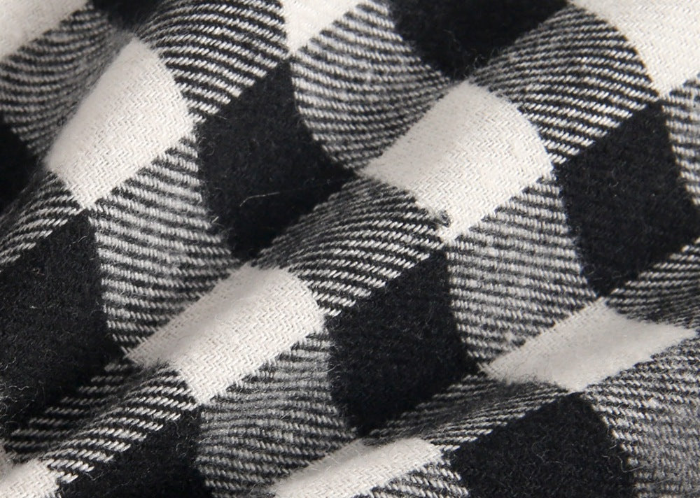 Baby girl long sleeve onesie featuring a plaid pattern and doll collar design in black and grey colors.