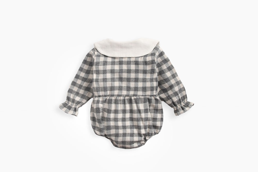 Baby girl long sleeve onesie featuring a plaid pattern and doll collar design in black and grey colors.