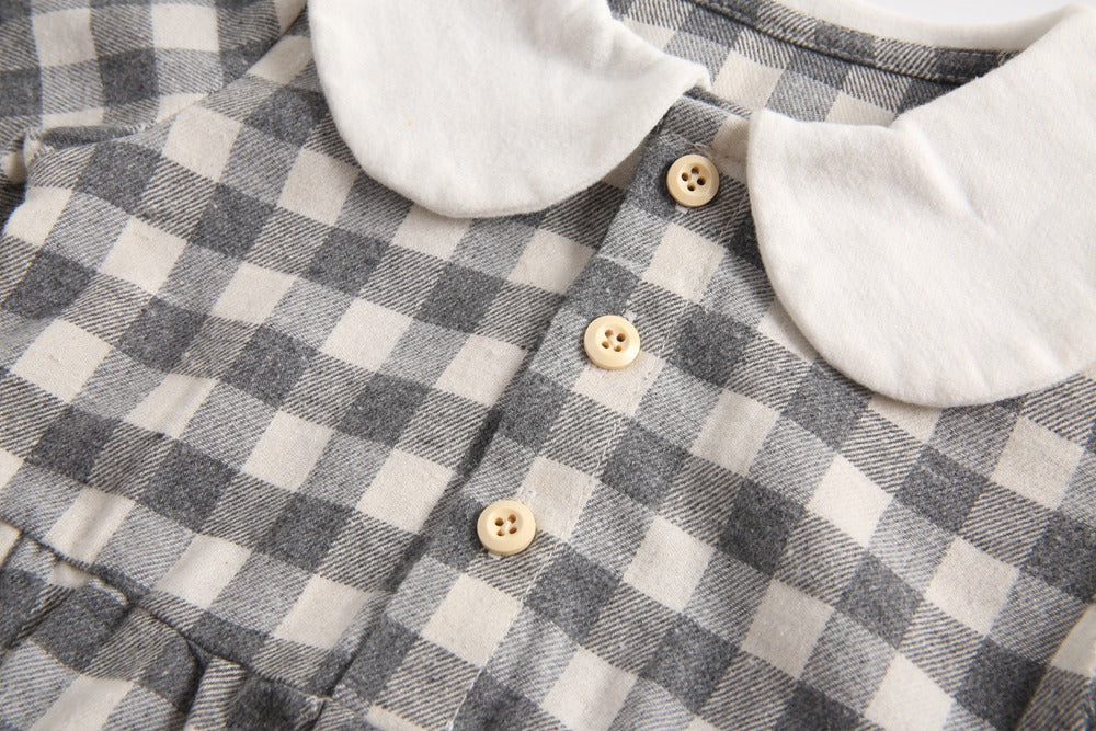 Baby girl long sleeve onesie featuring a plaid pattern and doll collar design in black and grey colors.