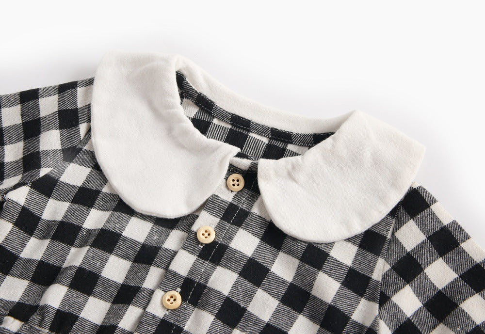 Baby girl long sleeve onesie featuring a plaid pattern and doll collar design in black and grey colors.