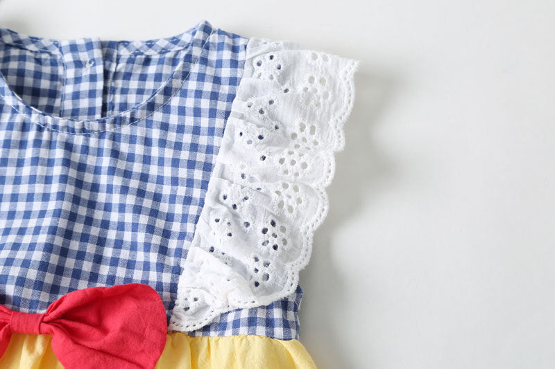 Baby girl sleeveless onesie featuring plaid pattern, lace patchwork, and bow in vibrant yellow color.