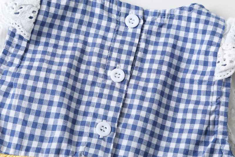 Baby girl sleeveless onesie featuring plaid pattern, lace patchwork, and bow in vibrant yellow color.