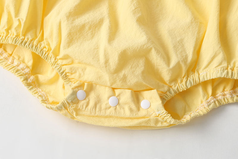 Baby girl sleeveless onesie featuring plaid pattern, lace patchwork, and bow in vibrant yellow color.