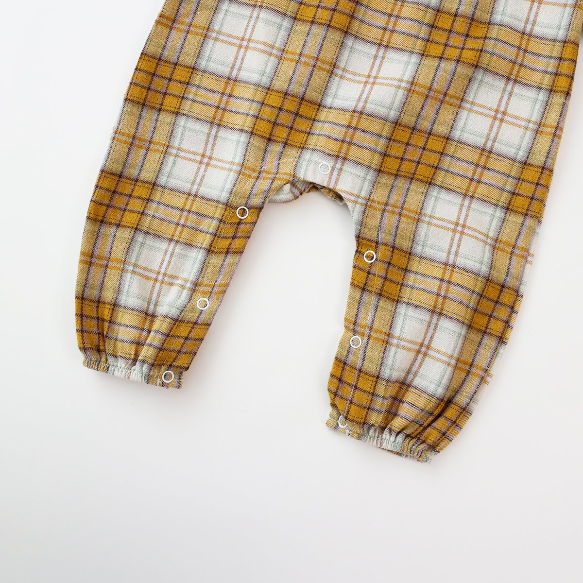 Baby girl romper featuring a plaid pattern and mesh patchwork design with a doll neck bow tie, available in pink and yellow.