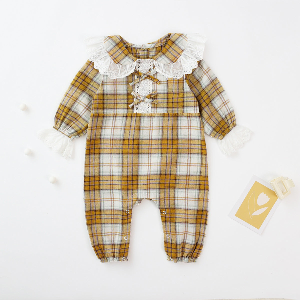 Baby girl romper featuring a plaid pattern and mesh patchwork design with a doll neck bow tie, available in pink and yellow.
