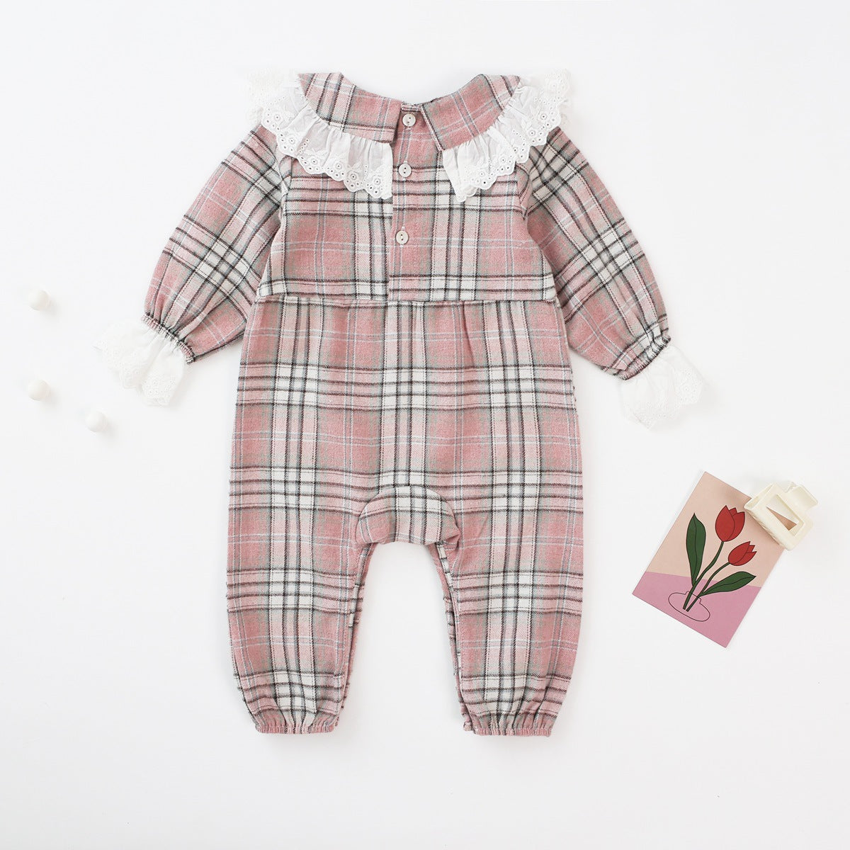 Baby girl romper featuring a plaid pattern and mesh patchwork design with a doll neck bow tie, available in pink and yellow.