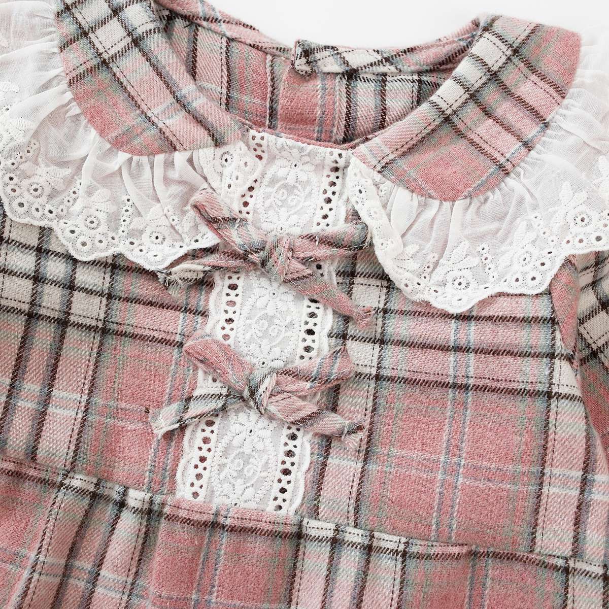 Baby girl romper featuring a plaid pattern and mesh patchwork design with a doll neck bow tie, available in pink and yellow.