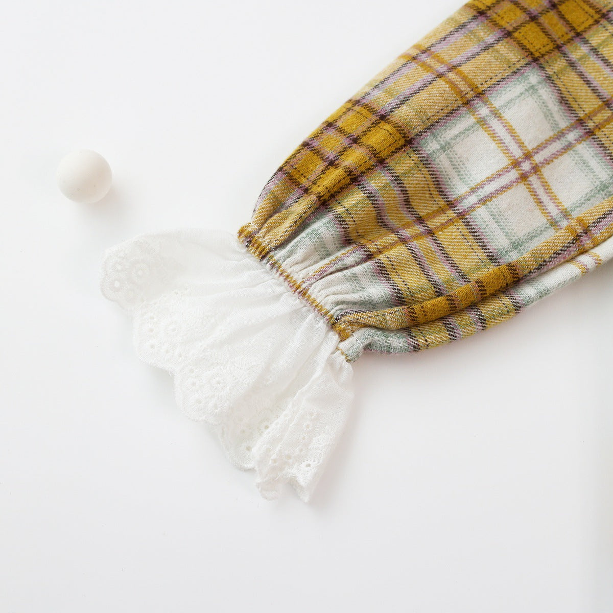 Baby girl romper featuring a plaid pattern and mesh patchwork design with a doll neck bow tie, available in pink and yellow.