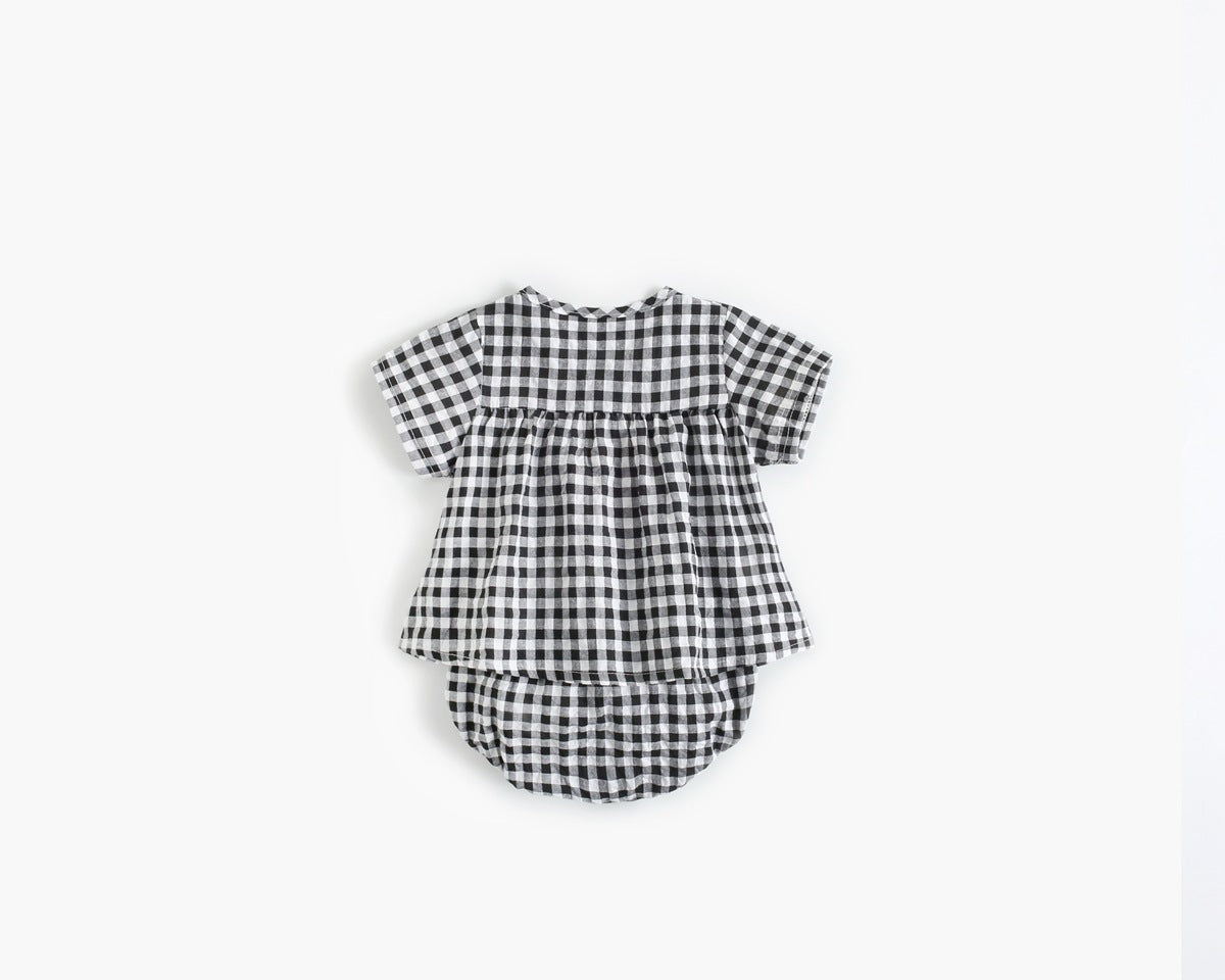 Baby girl wearing a plaid pattern shirt and shorts set in black and yellow, perfect for summer outings.
