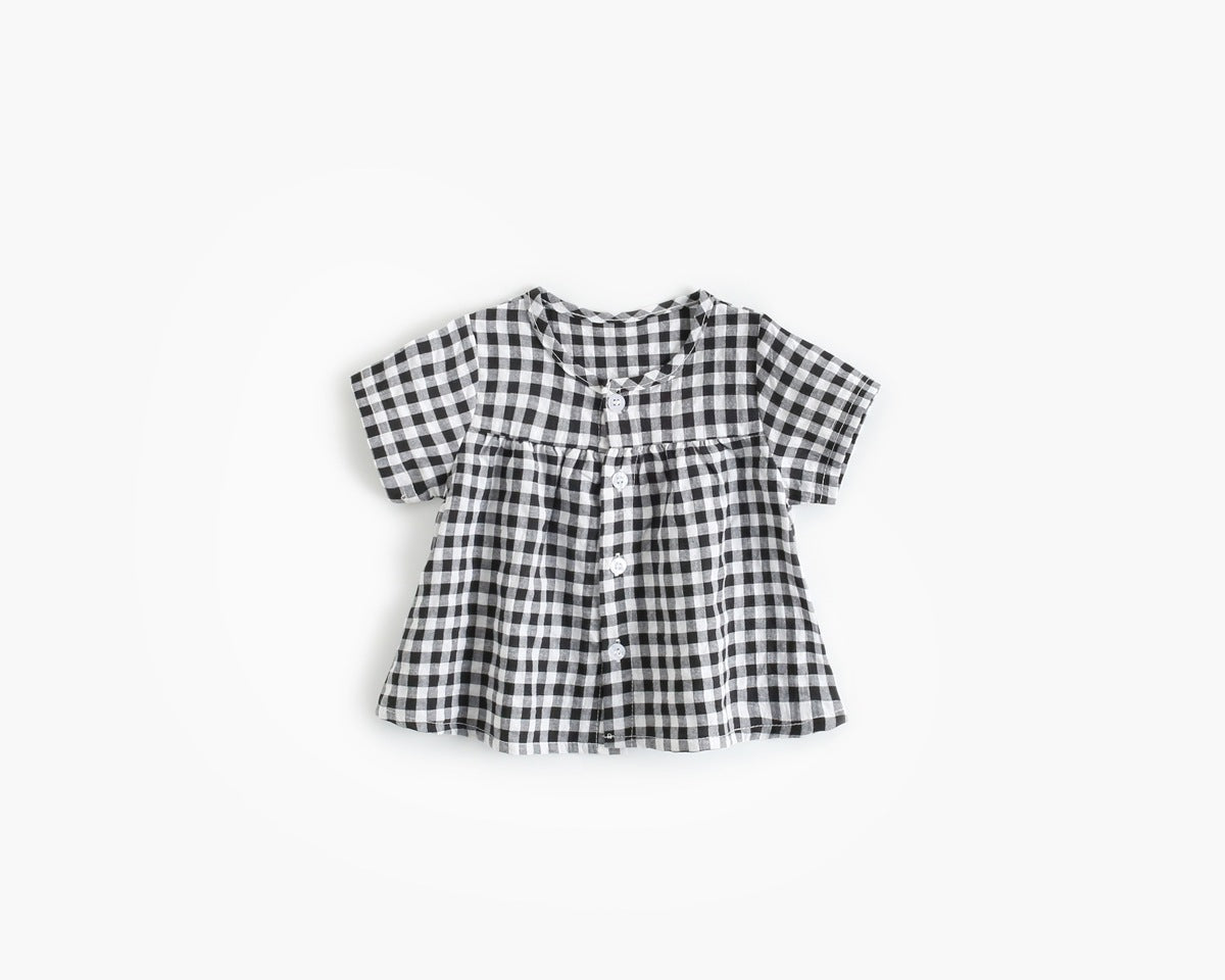 Baby girl wearing a plaid pattern shirt and shorts set in black and yellow, perfect for summer outings.