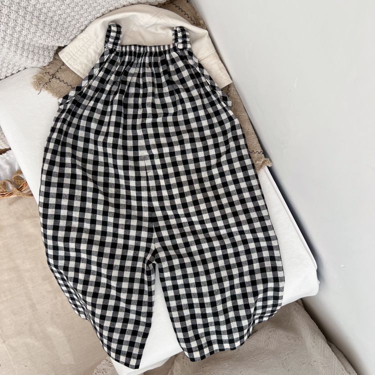 Baby girl wearing a plaid pattern sleeveless strap romper, showcasing a stylish design perfect for spring and summer.