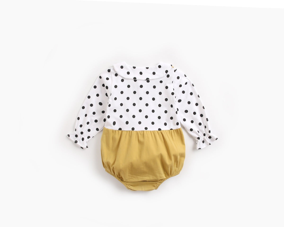 Baby girl wearing a stylish yellow polka dot onesie with a doll collar design and backless long sleeves.