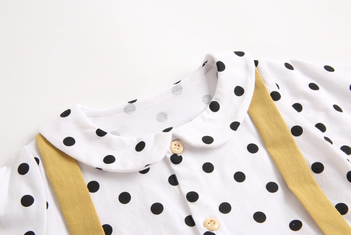 Baby girl wearing a stylish yellow polka dot onesie with a doll collar design and backless long sleeves.