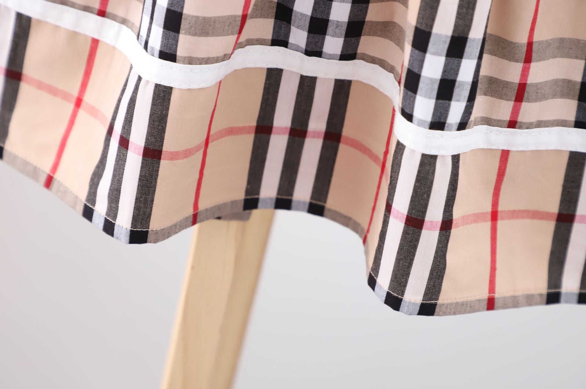 Baby girl dress featuring a doll collar design in khaki color with a plaid pattern, perfect for summer occasions.