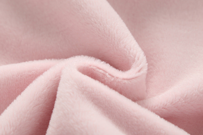 Baby girl wearing a cute rabbit ear design long sleeved onesie in pink, showcasing a playful print pattern.