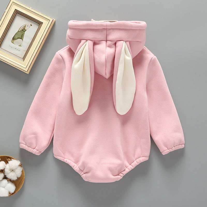 Baby girl wearing a cute rabbit ear design long sleeved onesie in pink, showcasing a playful print pattern.