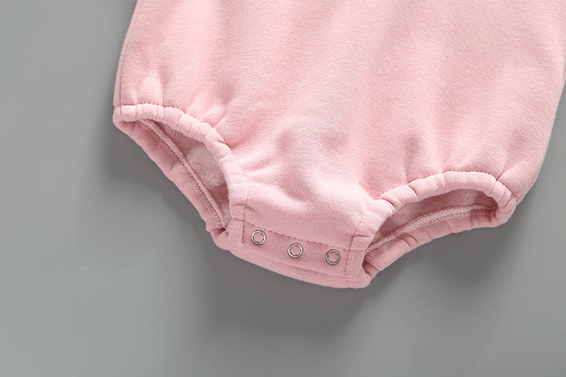 Baby girl wearing a cute rabbit ear design long sleeved onesie in pink, showcasing a playful print pattern.