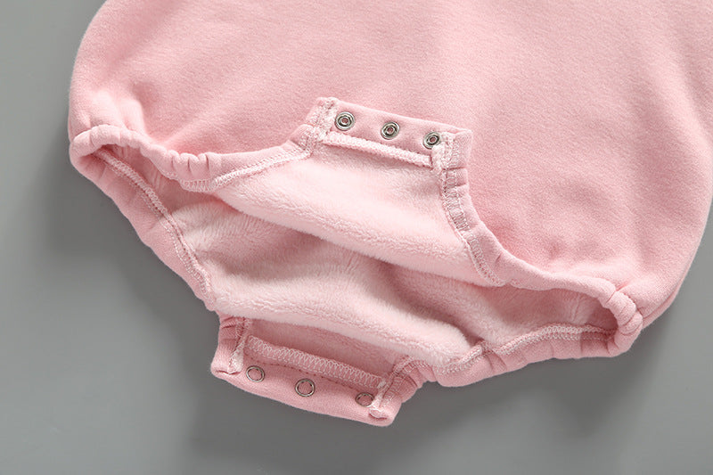 Baby girl wearing a cute rabbit ear design long sleeved onesie in pink, showcasing a playful print pattern.