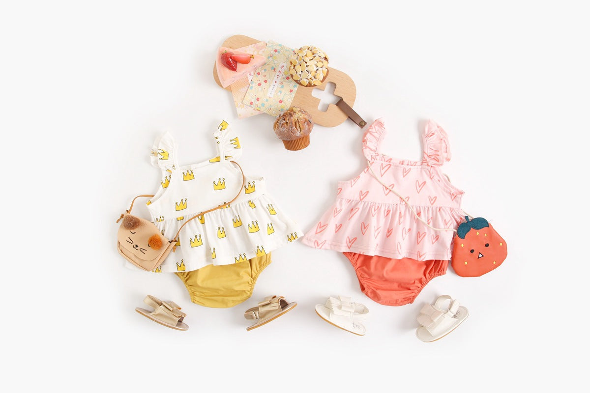 Adorable baby girl outfit featuring a ruffle sleeveless top and matching shorts with a heart printed pattern in pink and yellow.