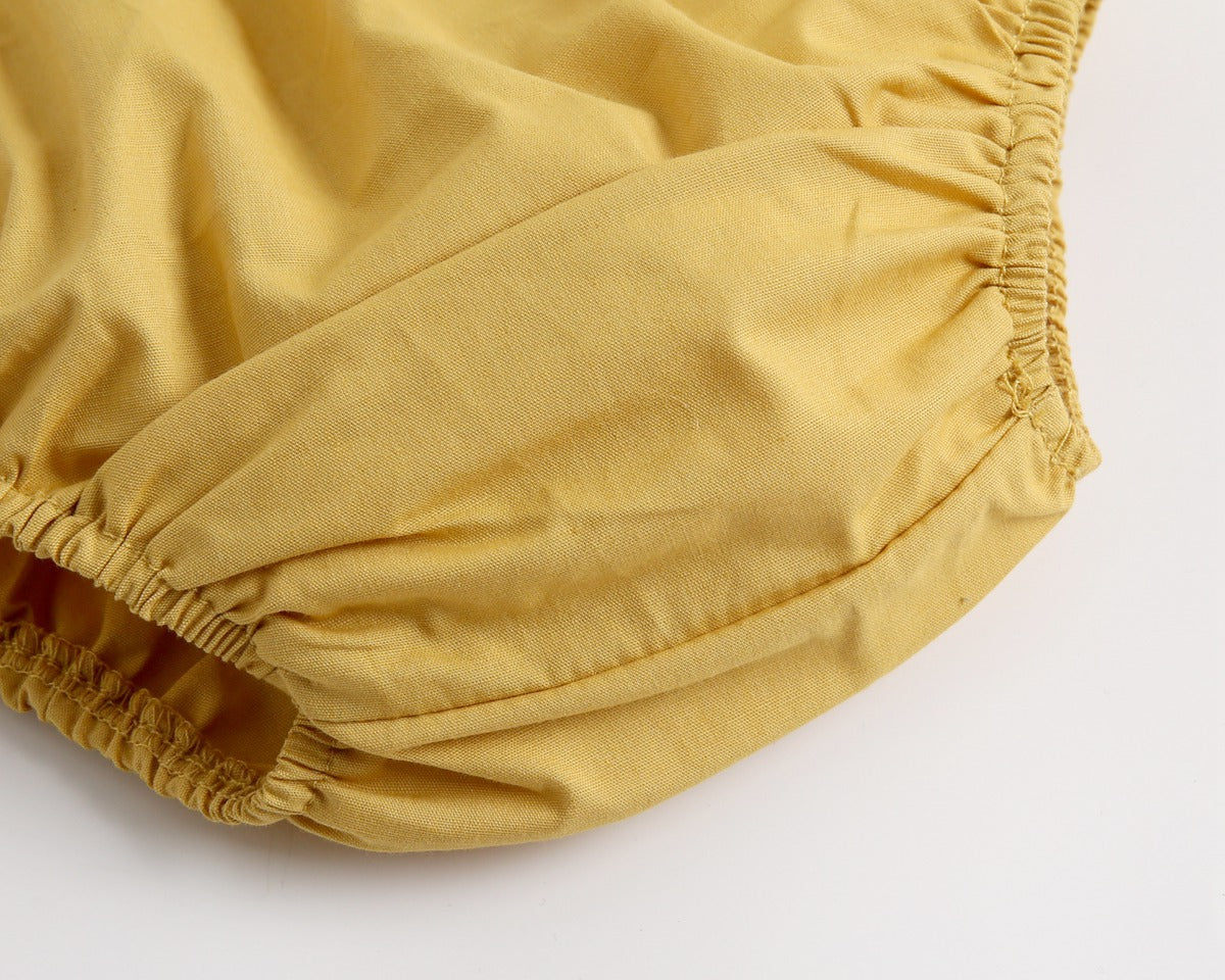 Adorable baby girl outfit featuring a ruffle sleeveless top and matching shorts with a heart printed pattern in pink and yellow.