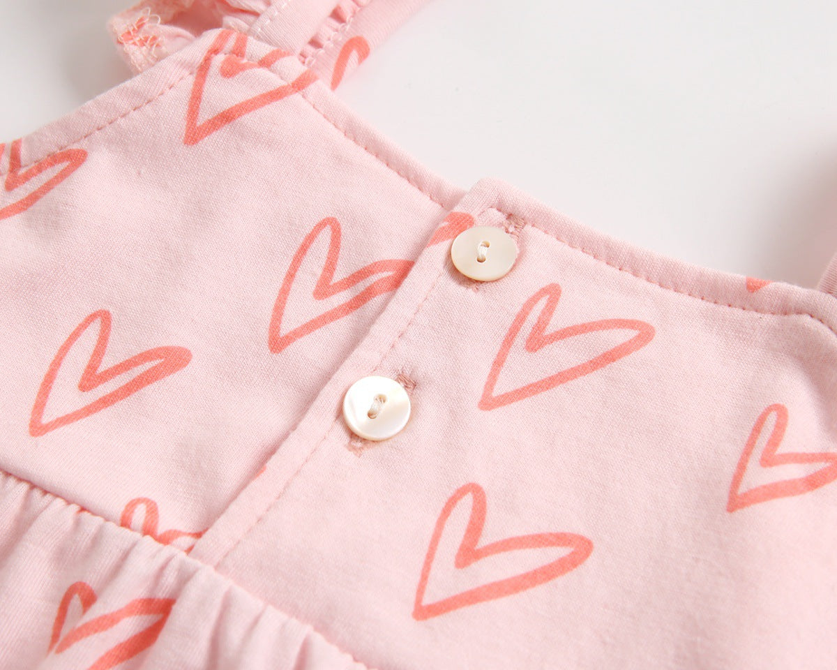 Adorable baby girl outfit featuring a ruffle sleeveless top and matching shorts with a heart printed pattern in pink and yellow.