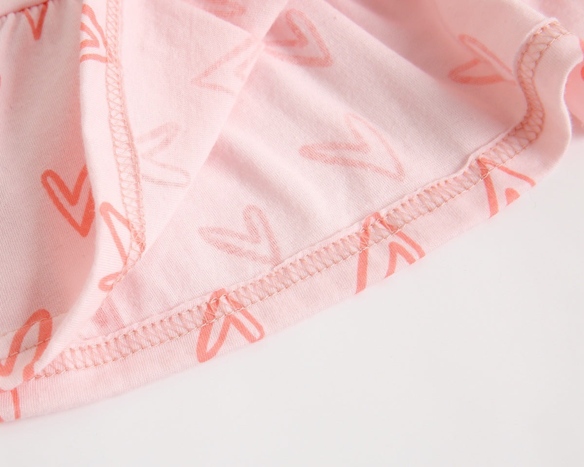 Adorable baby girl outfit featuring a ruffle sleeveless top and matching shorts with a heart printed pattern in pink and yellow.