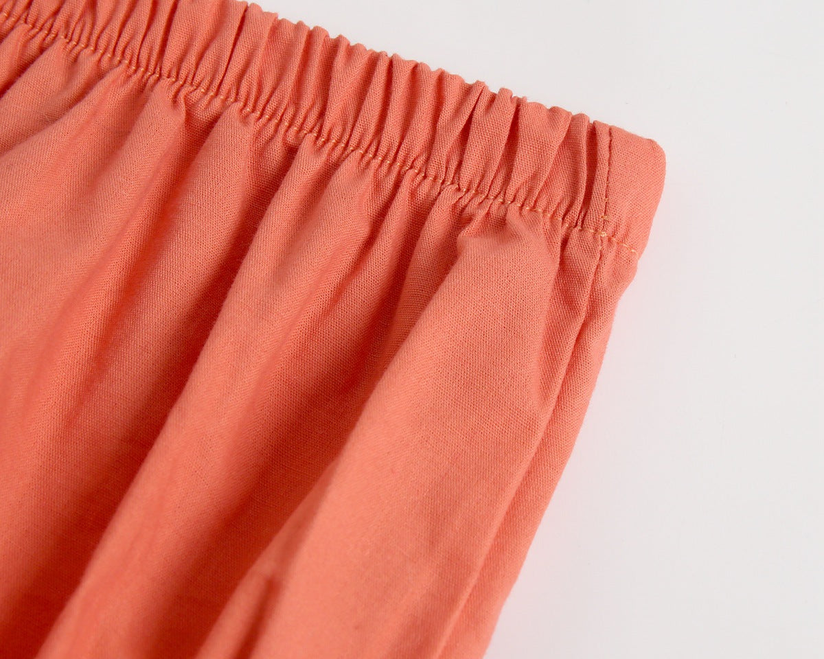 Adorable baby girl outfit featuring a ruffle sleeveless top and matching shorts with a heart printed pattern in pink and yellow.