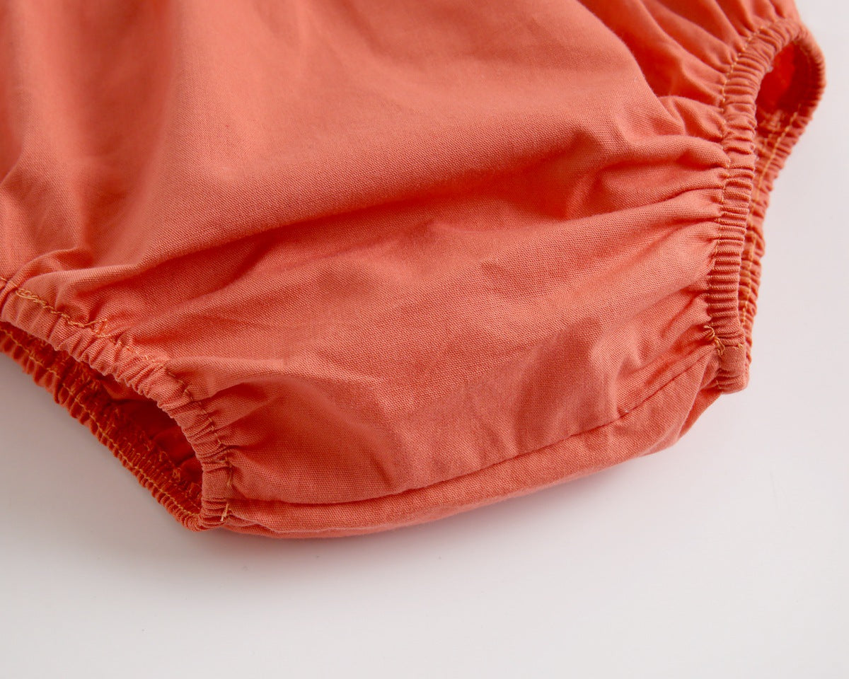 Adorable baby girl outfit featuring a ruffle sleeveless top and matching shorts with a heart printed pattern in pink and yellow.