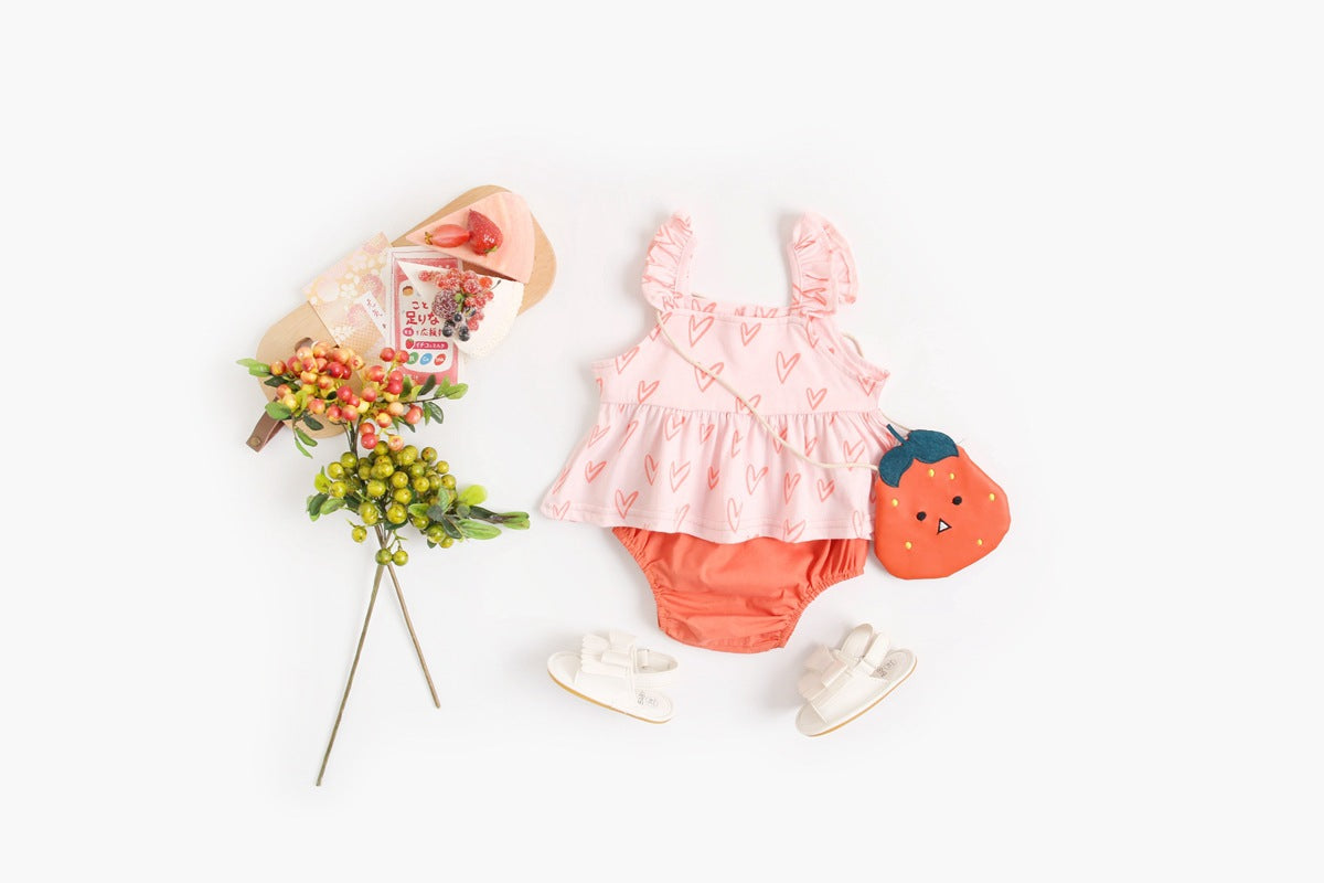 Adorable baby girl outfit featuring a ruffle sleeveless top and matching shorts with a heart printed pattern in pink and yellow.