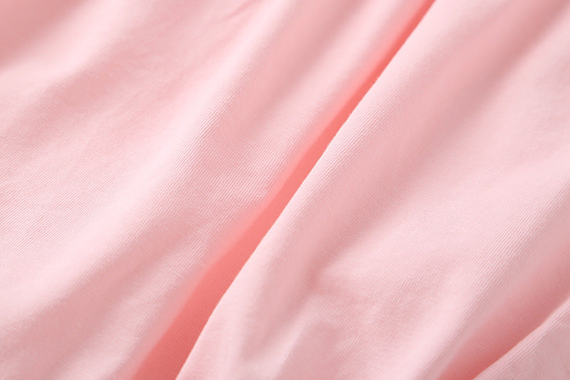 Adorable baby girl onesie featuring a round collar, short sleeves, and a small daisy pattern in pink cotton fabric.