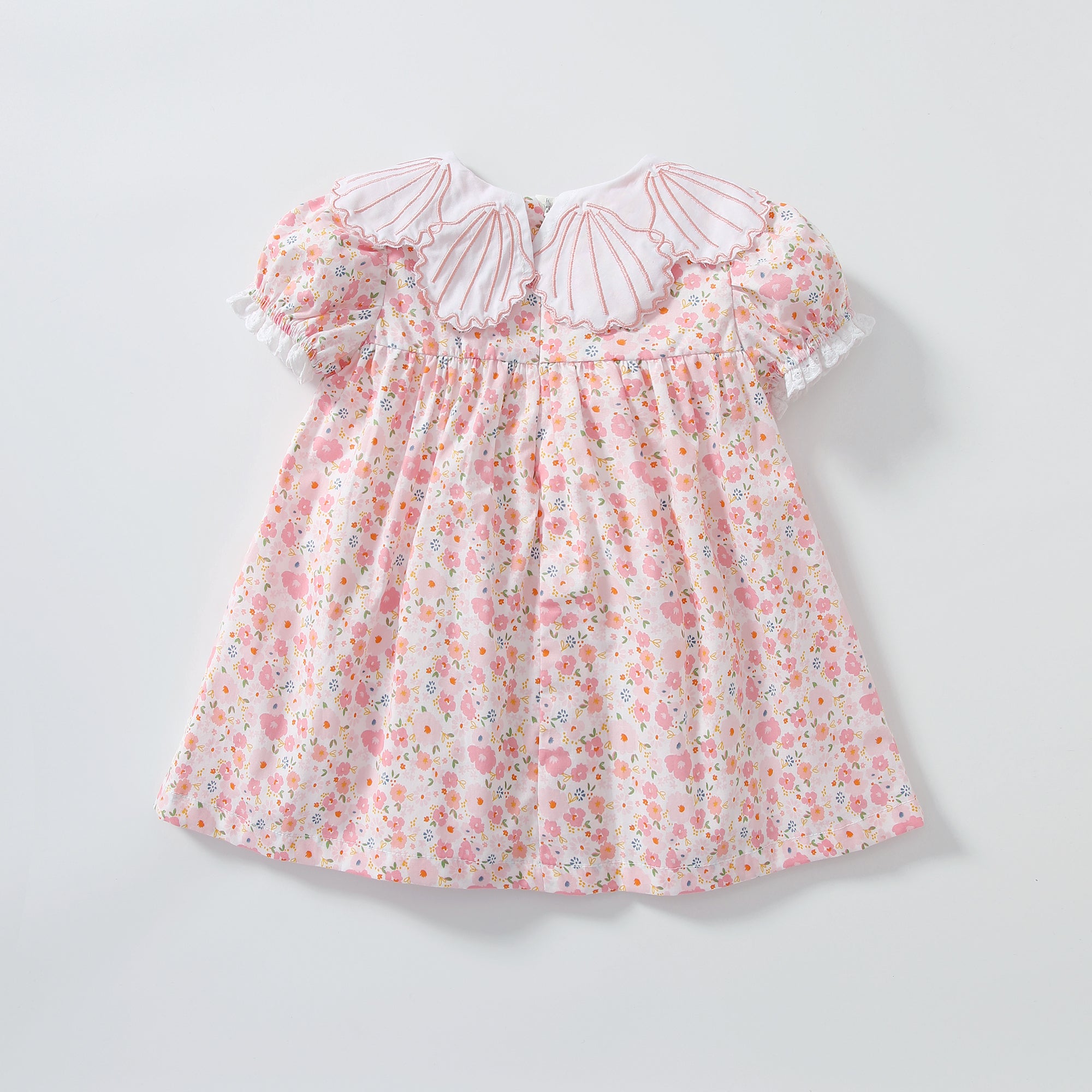 Baby girl dress featuring a floral print and shell shape collar, perfect for summer occasions.