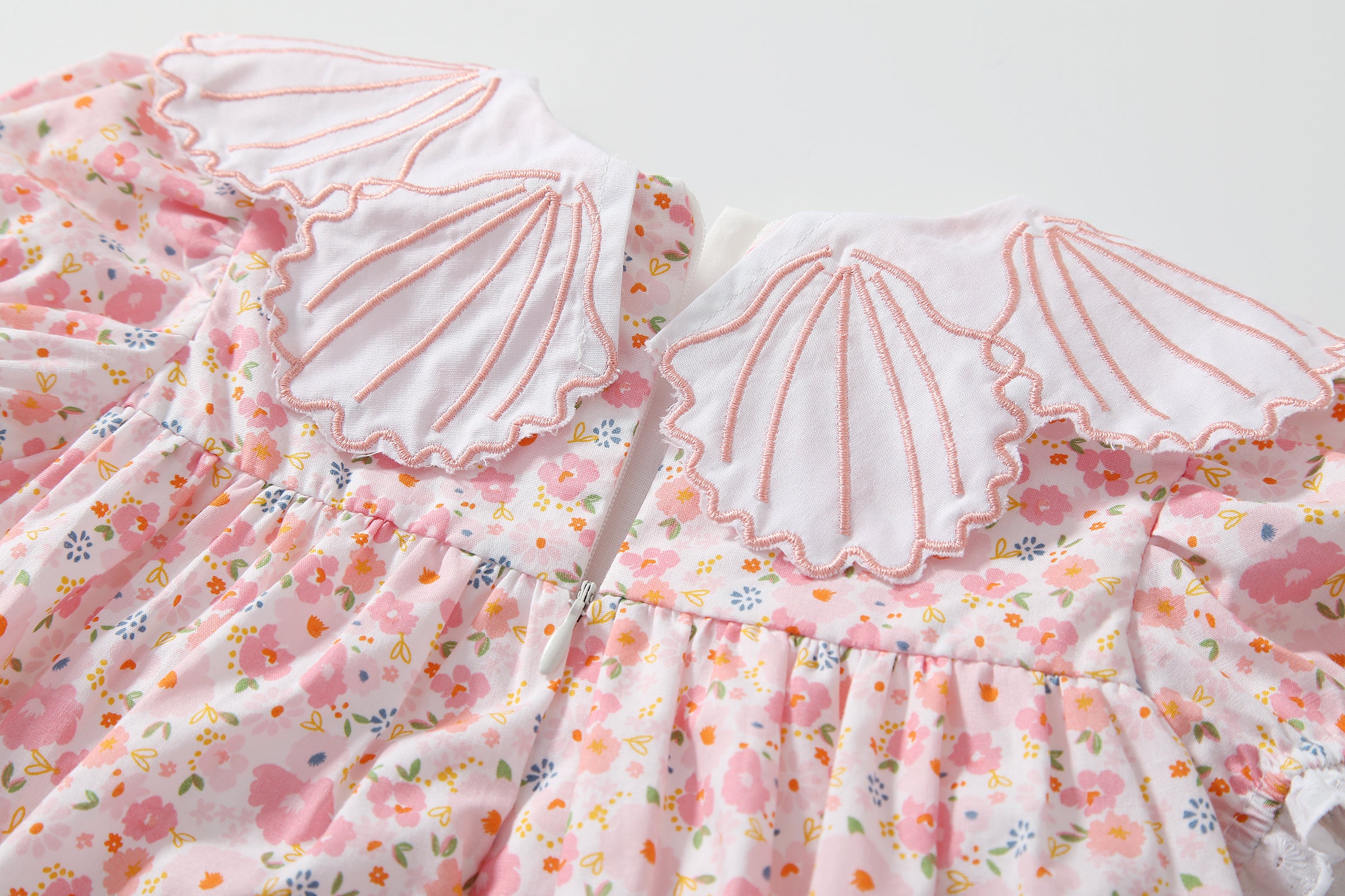 Baby girl dress featuring a floral print and shell shape collar, perfect for summer occasions.