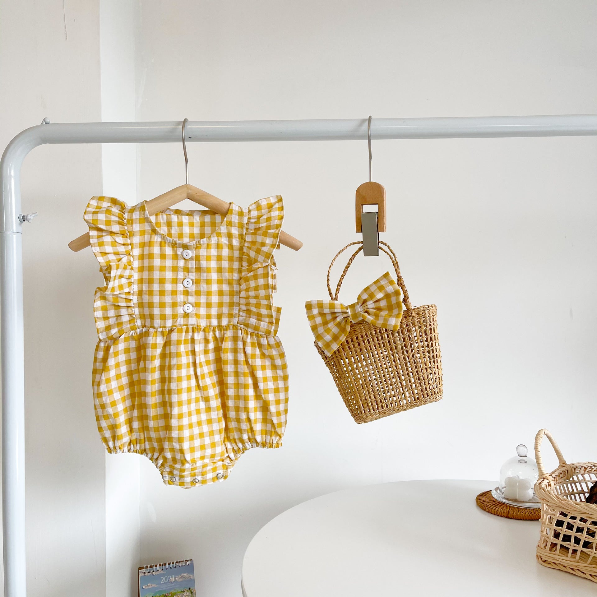 Baby girl sleeveless onesie featuring a stylish grid pattern in black and yellow, perfect for summer wear.