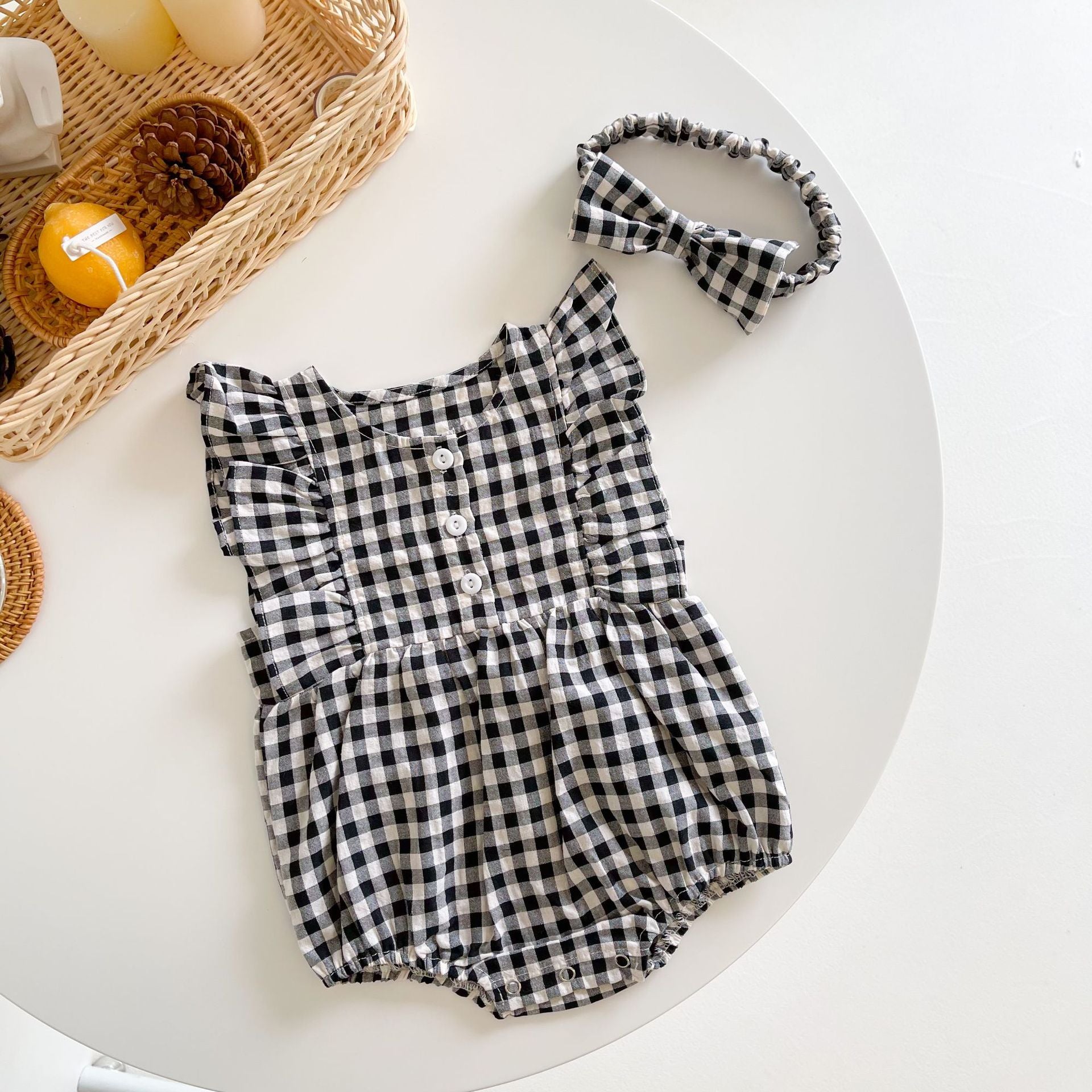 Baby girl sleeveless onesie featuring a stylish grid pattern in black and yellow, perfect for summer wear.