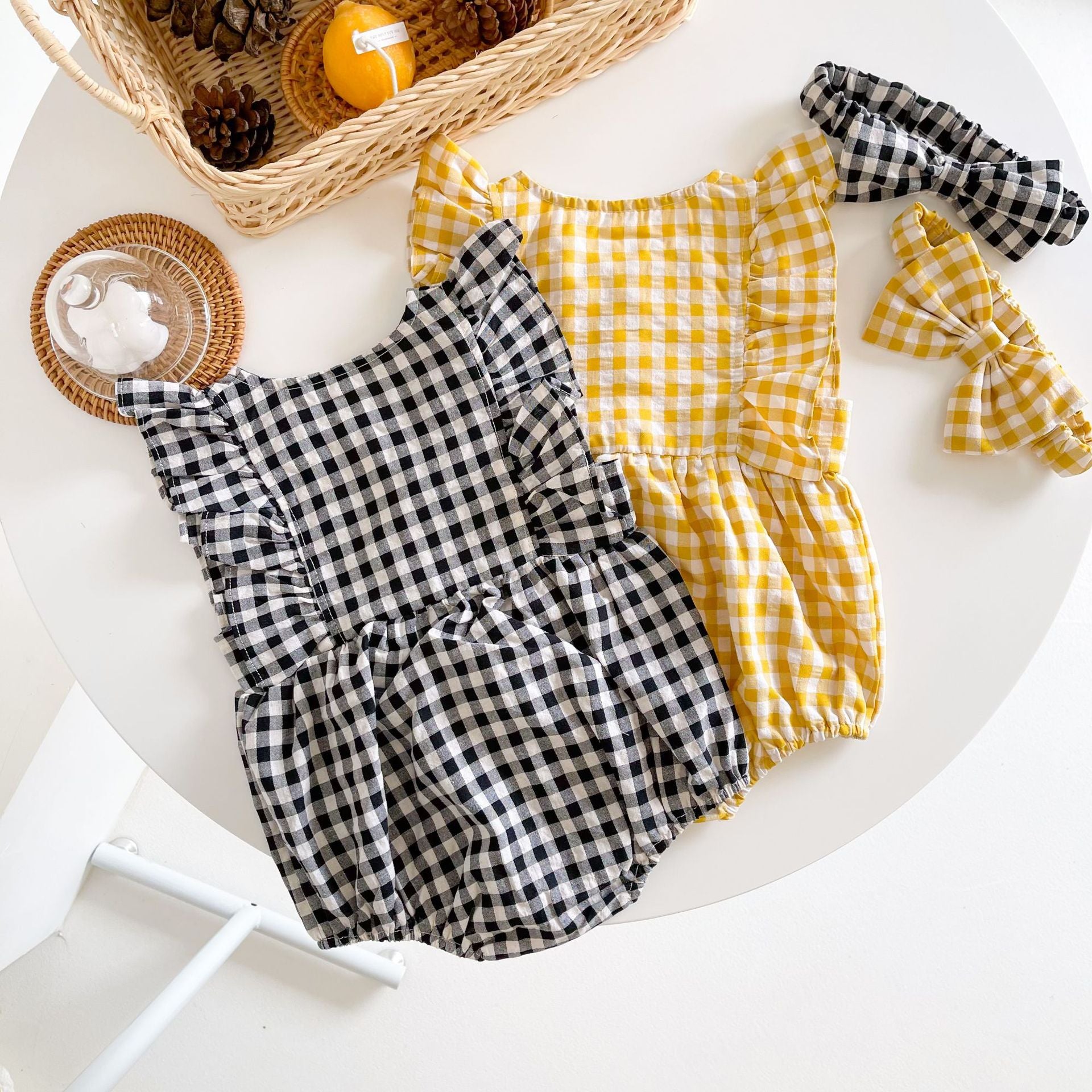 Baby girl sleeveless onesie featuring a stylish grid pattern in black and yellow, perfect for summer wear.