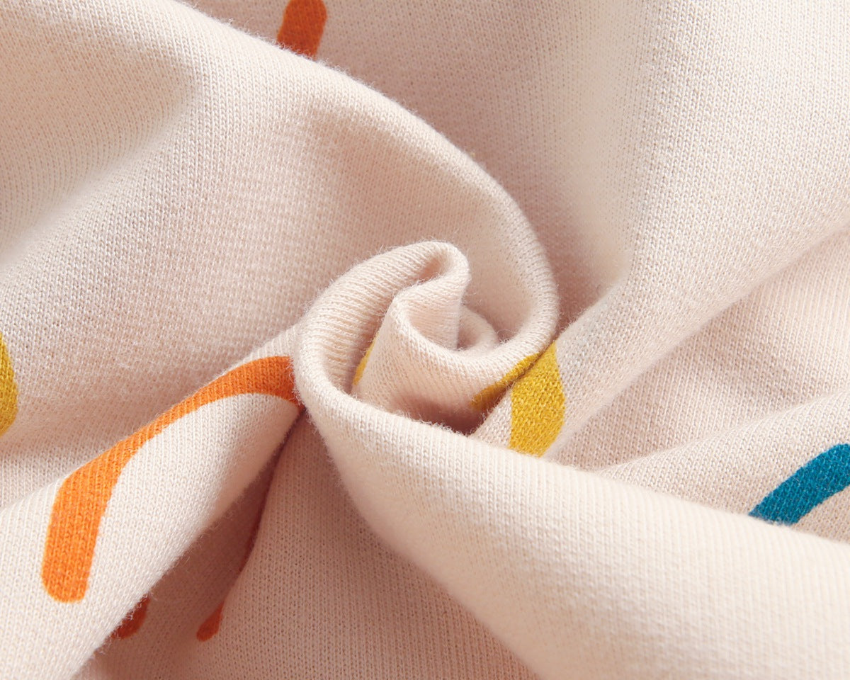 Baby girl long-sleeve romper with smiley print pattern in beige, featuring a single breasted design and covered button.