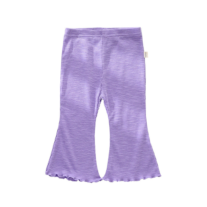 Adorable baby girl wearing solid color autumn bell-bottomed pants in various colors, showcasing the stylish design and comfortable fit.